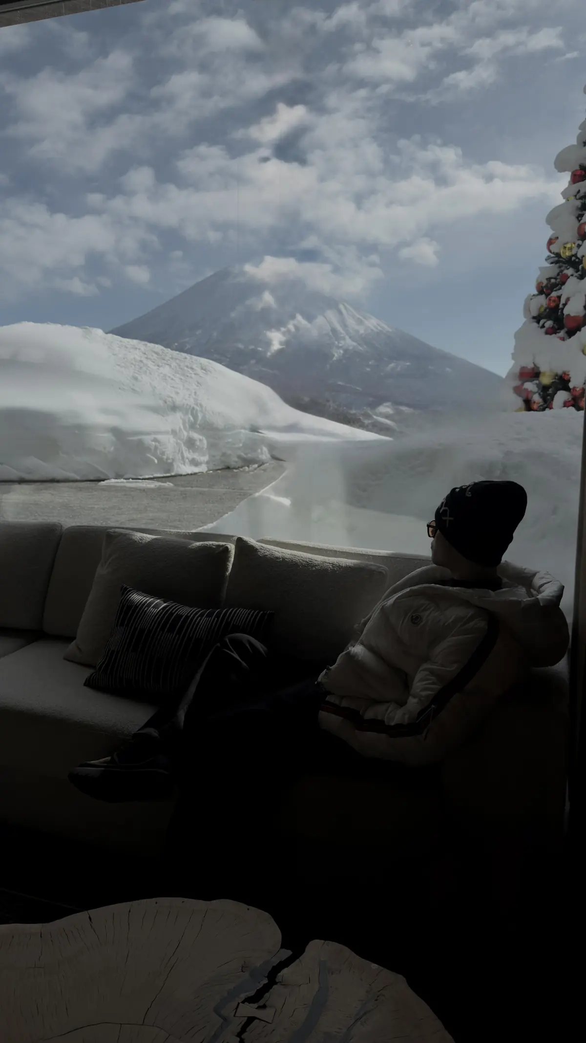 Vatana Pang looking out at a snowy mountain view